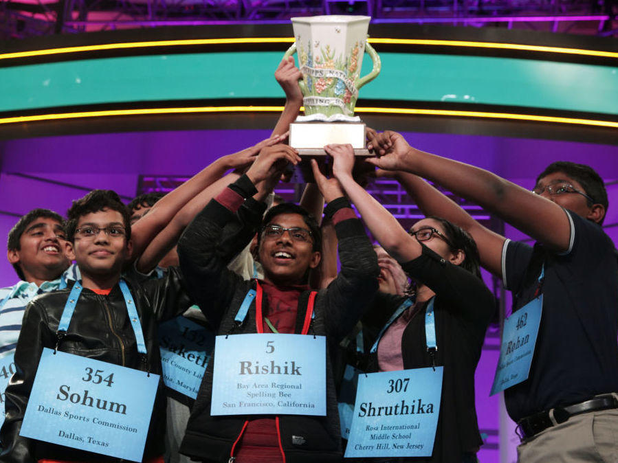 The 2019 Scripps Spelling Bee co-champions hold up their trophy at the Gaylord National Resort & Convention Center in National Harbor, Md. After pausing in 2020, the competition is back on this year. The finals are Thursday night in Orlando, Fla.