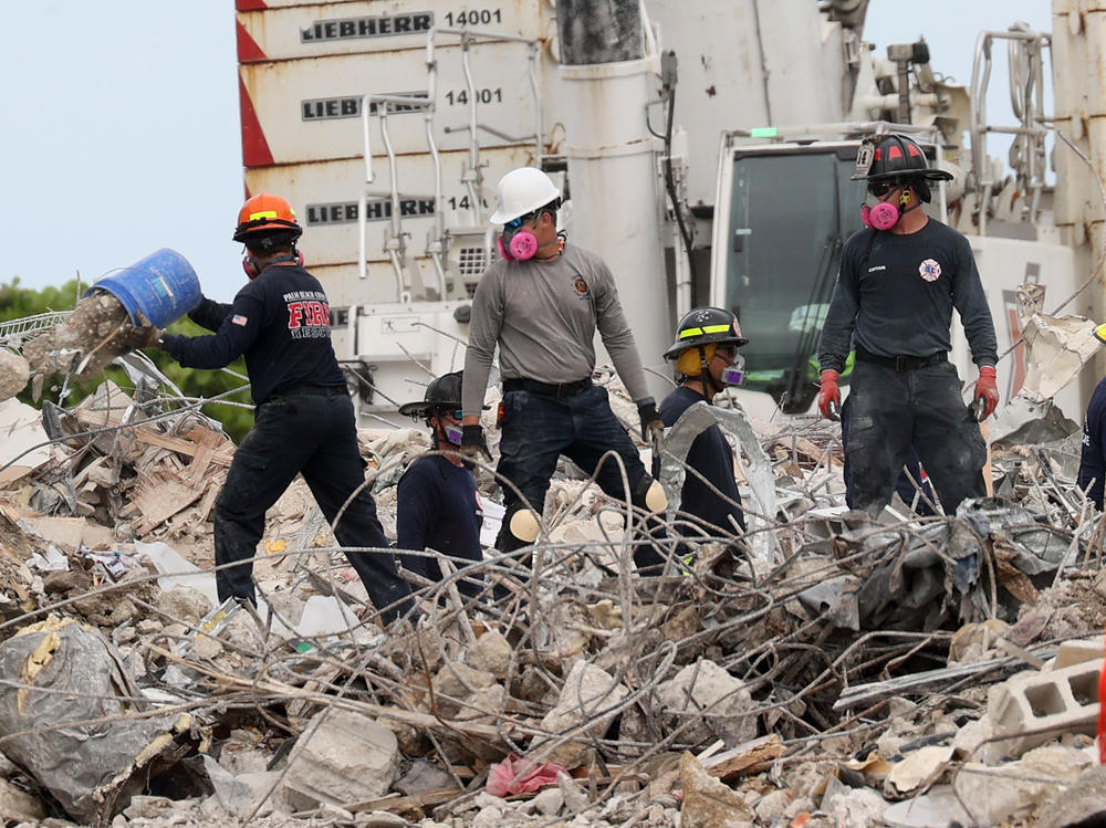 Search teams continue work Wednesday as efforts move into a recovery operation at the collapsed Champlain Towers South condo building in Surfside, Fla.