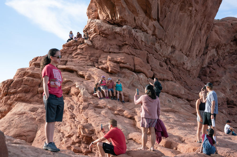 People take in North Window Arch in June at Arches National Park.