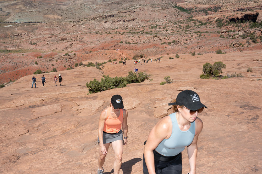 Visitors make the hike to Delicate Arch, 3 miles round trip.