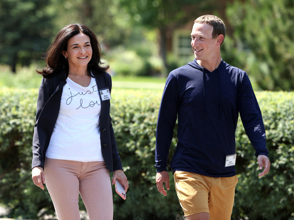 Facebook CEO Mark Zuckerberg walks with Facebook COO Sheryl Sandberg at the Sun Valley conference.