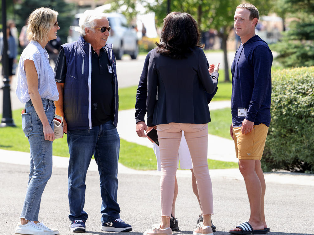 From left to right, Dana Blumberg stands next to her boyfriend, New England Patriots owner Robert Kraft, Facebook COO Sheryl Sandberg and Facebook CEO Mark Zuckerberg as they talk after a session at the Allen & Company Sun Valley Conference on Thursday in Sun Valley, Idaho. Top execs across media, tech and sports gathered for their annual event known as 