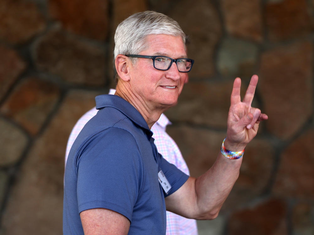 Apple CEO Tim Cook waves at photographers as he attends the Sun Valley Conference on Thursday.
