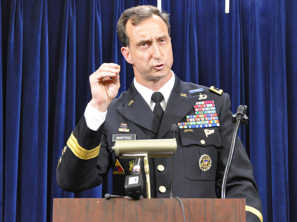 Army Brig. Gen. Mark Martins, Guantánamo's chief prosecutor, addresses the media on Oct. 19, 2012, at the end of a week of pretrial hearings for the five alleged architects of the 9/11 attacks. Martins announced his retirement this week.