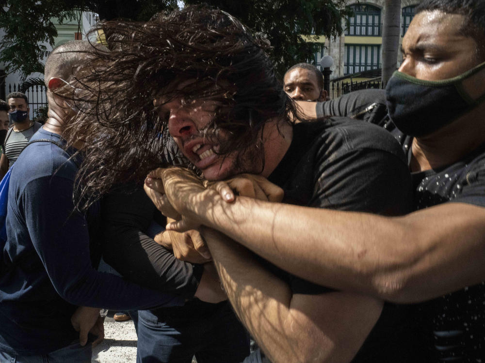 Plainclothes police detain an anti-government protester during a protest in Havana, Cuba, on Sunday. Hundreds of demonstrators went out to the streets in several cities in Cuba to protest against ongoing food shortages and high prices of foodstuffs.