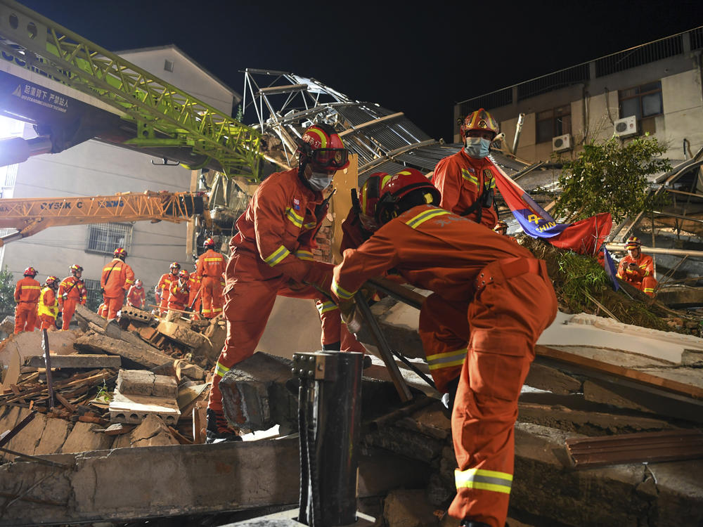 In this photo released by Xinhua News Agency, rescuers prepare equipment as they search for survivors at a collapsed hotel in Suzhou in eastern China's Jiangsu Province on Monday.