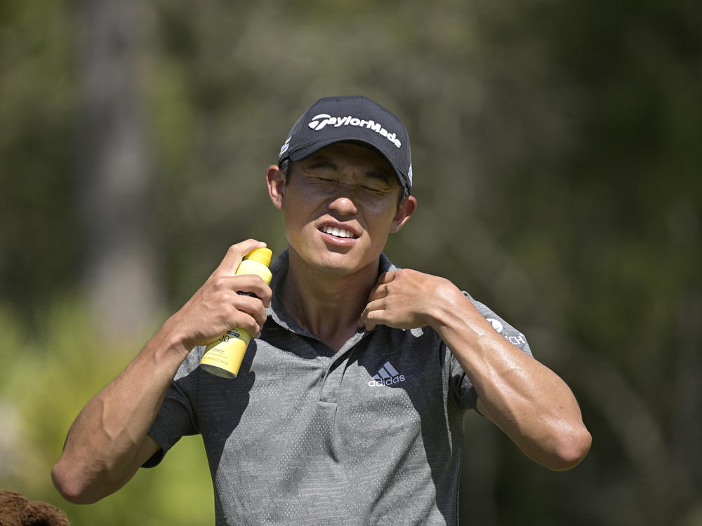 Johnson & Johnson recalled five aerosol sunscreen products after finding traces of benzene. In this photo, Collin Morikawa sprays himself with sunscreen during the Workday Championship golf tournament in February.