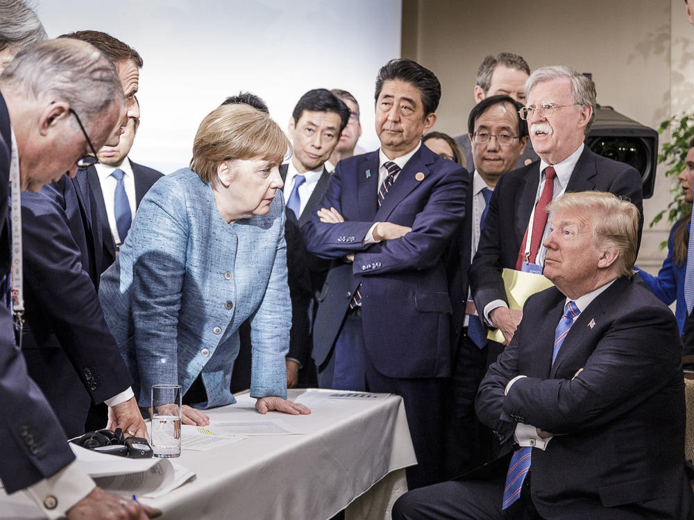 In an exchange that seemed to symbolize their often tense relationship, Merkel deliberates with Trump on the sidelines of the 2017 G-7 summit in Charlevoix, Quebec.