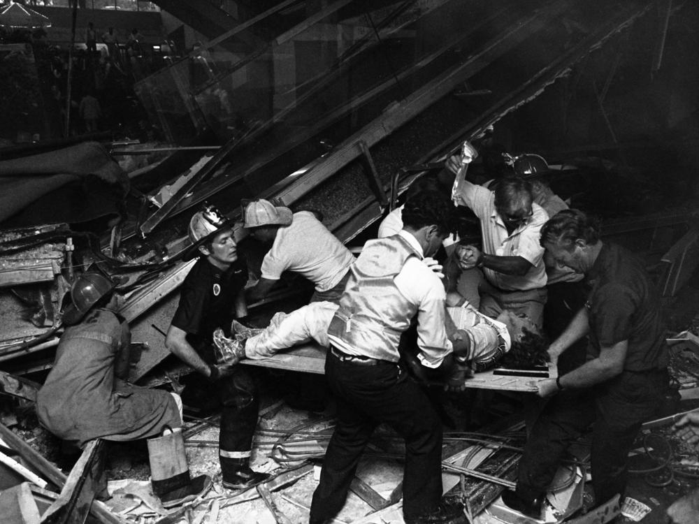 Firefighters rescue people from under a collapsed walkway in the lobby of the Hyatt Regency Hotel in Kansas City, Mo., on July 17, 1981. The collapse killed 114 people and injured more than 200.