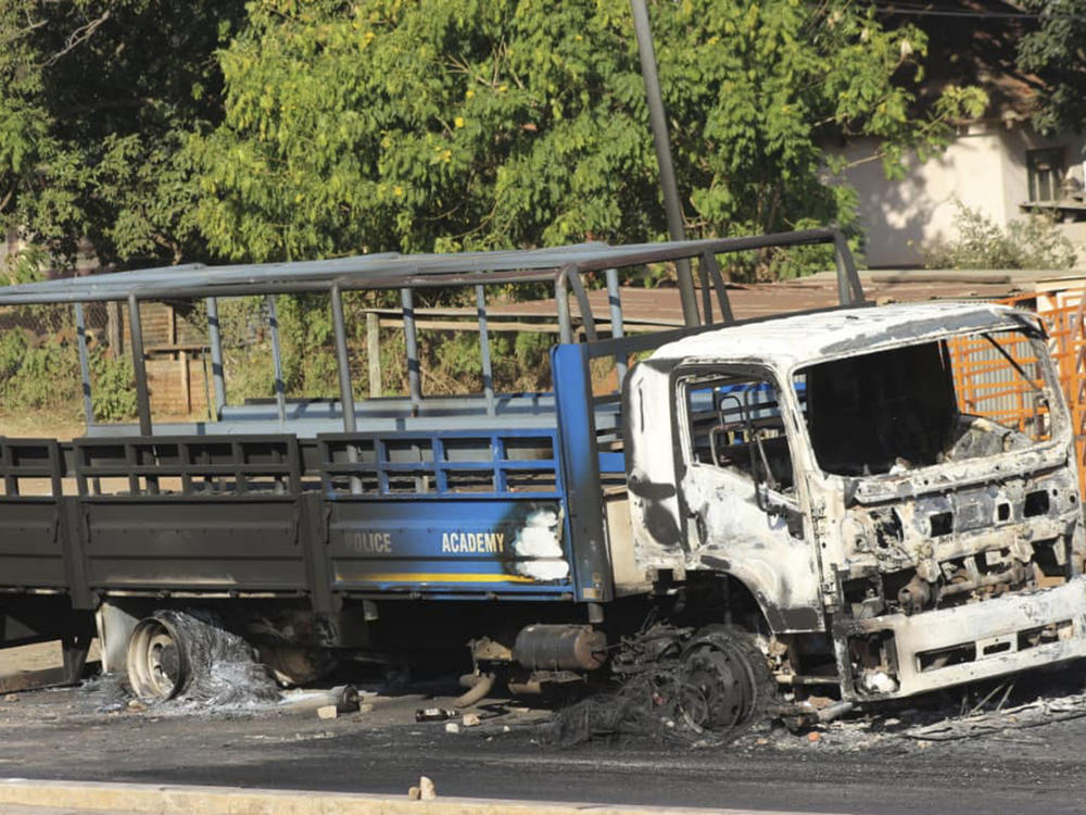 A burned police academy truck on the side of the road in Manzini, Eswatini, on June 30.