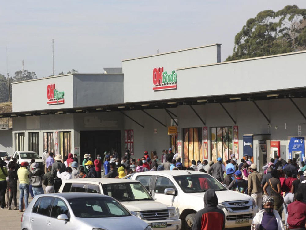 People queue to buy food at a supermarket in Mbabane, Eswatini, on July 1. Demonstrations escalated as protesters have taken to the streets demanding political reforms. Two-thirds of the population lives below the poverty line.