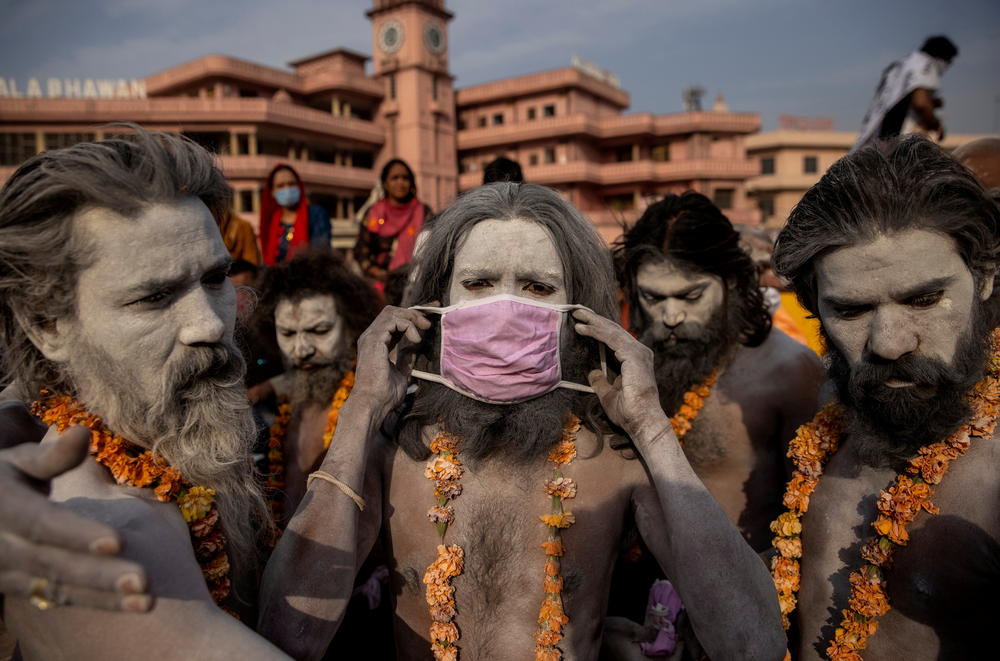 A Naga Sadhu, or Hindu holy man, wears a mask before the procession for taking a dip in the Ganges River during Shahi Snan at 