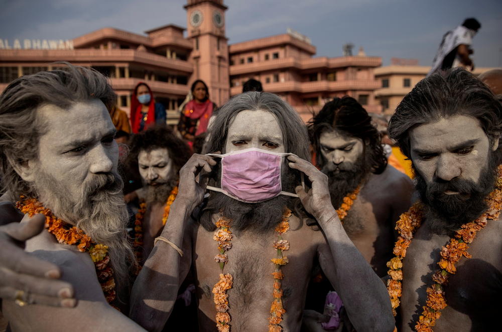 A Naga Sadhu, or Hindu holy man, wears a mask before the procession for taking a dip in the Ganges River during Shahi Snan at 