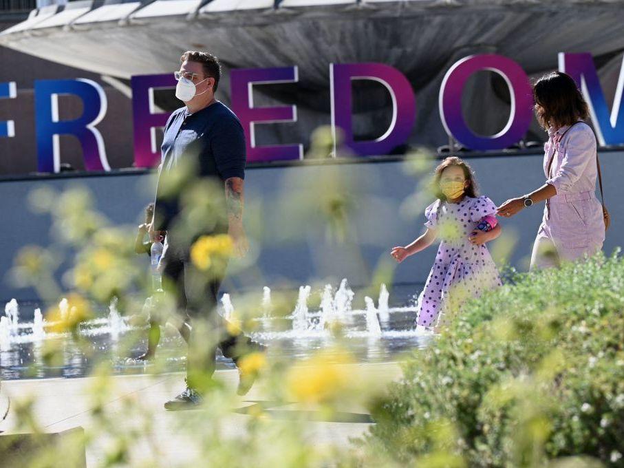 People enjoy an outdoor art exhibition in downtown Los Angeles in early July. Los Angeles County public health authorities are now urging unvaccinated and vaccinated people alike to wear face coverings in public indoor spaces because of the growing threat posed by the more contagious delta variant.