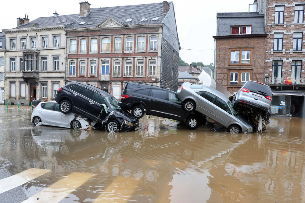 Cars are piled up by the water at a roundabout Thursday in Verviers, Belgium, after heavy rains and floods lashed Western Europe.