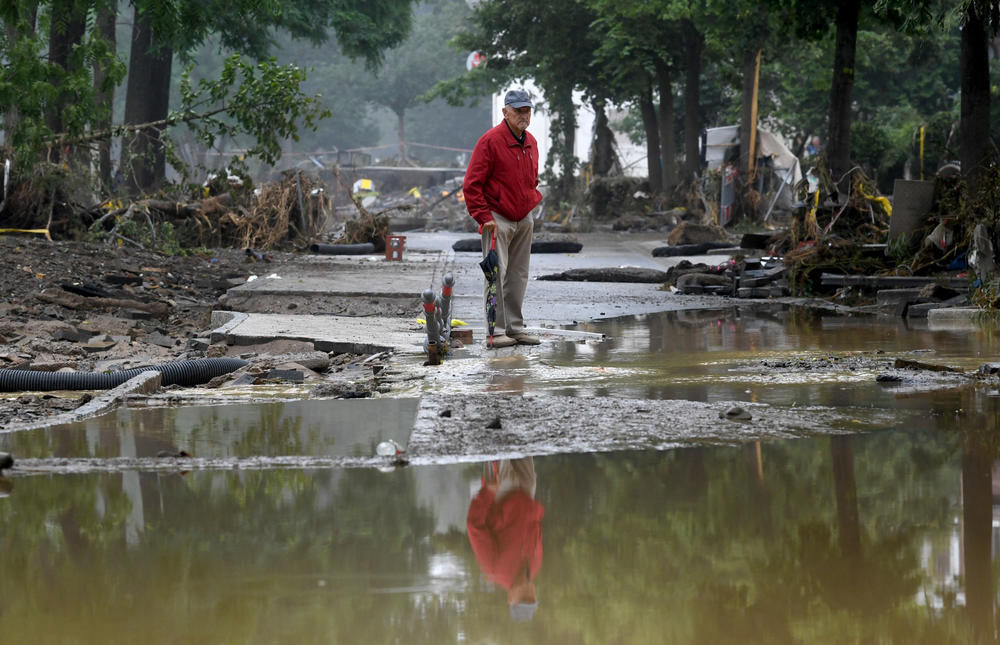 A man stands amid rubble Friday after floods caused major damage in Bad Neuenahr-Ahrweiler, Germany.