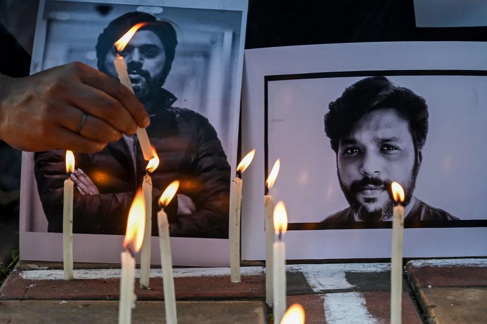 Candles are placed by journalists next to portraits of Danish Siddiqui as a tribute in Kolkata, India, on Friday, after the Pulitzer Prize-winning photographer with the Reuters news agency was killed covering fighting between Afghan security forces and the Taliban.