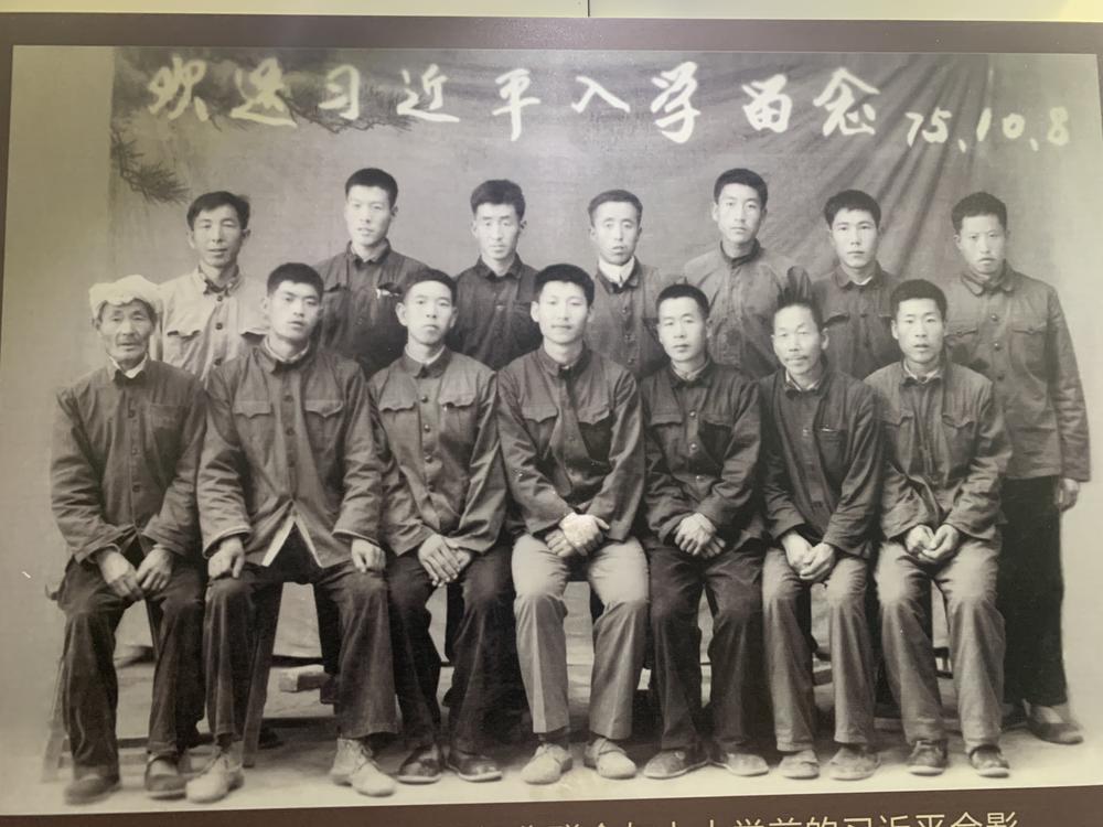 In a photo displayed in an exhibition in Liangjiahe,<strong> </strong>a young Xi Jinping (front row, center) is pictured in 1975 with fellow party members on the day he left Liangjiahe to attend university.