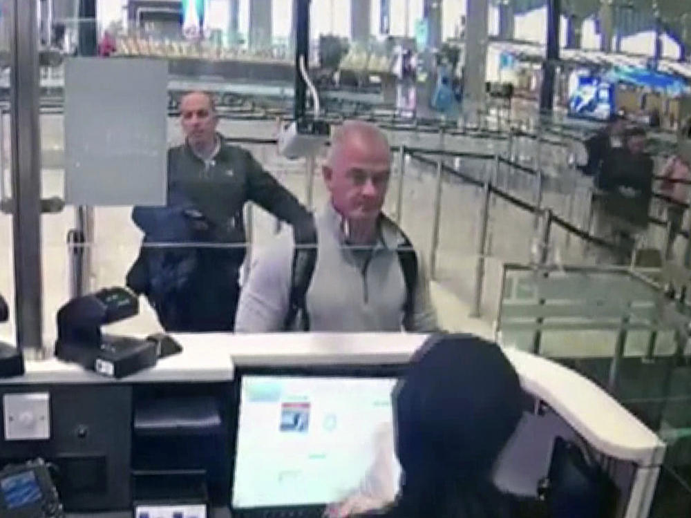 This Dec. 30, 2019, image from security camera video shows Michael L. Taylor, center, and George-Antoine Zayek at passport control at Istanbul Airport in Turkey. A Tokyo court handed down prison terms for the American father Michael Taylor and son Peter accused of helping Nissan's former chairman, Carlos Ghosn, escape to Lebanon while awaiting trial in Japan.
