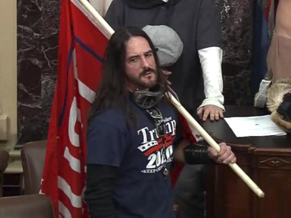 In this image from U.S. Capitol Police video, Paul Hodgkins of Tampa, Fla., stands in the well on the floor of the U.S. Senate on Jan. 6. On Monday, he was sentenced to eight months in prison.