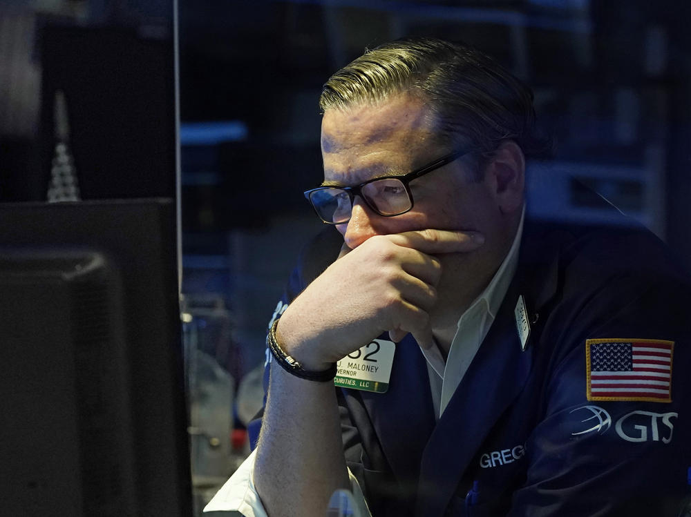 Gregg Maloney works on the floor of the New York Stock Exchange on Monday. Stocks fell sharply as coronavirus infections tied to the delta variant surged around the world, raising concerns about the global economy.
