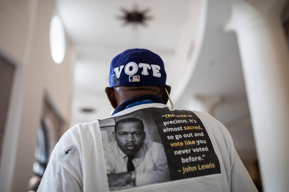 Edward Jones wears a baseball hat with the word Vote on it in the Texas State Capitol while he and others wait to testify before House and Senate committees, which began hearings on election integrity bills, on July 10, 2021 in Austin. Texas Republicans are moving forward with their effort to overhaul the state's voting laws during the 87th Legislatures' special session.