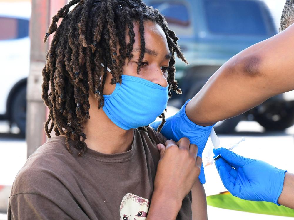 COVID-19 cases across the U.S. are rising in all 50 states as the delta variant of the coronavirus spreads. Here, a teenager receives a COVID-19 vaccine on July 16 at a mobile vaccine clinic hosted by Mothers in Action and operated by the Los Angeles County Department of Public Health.