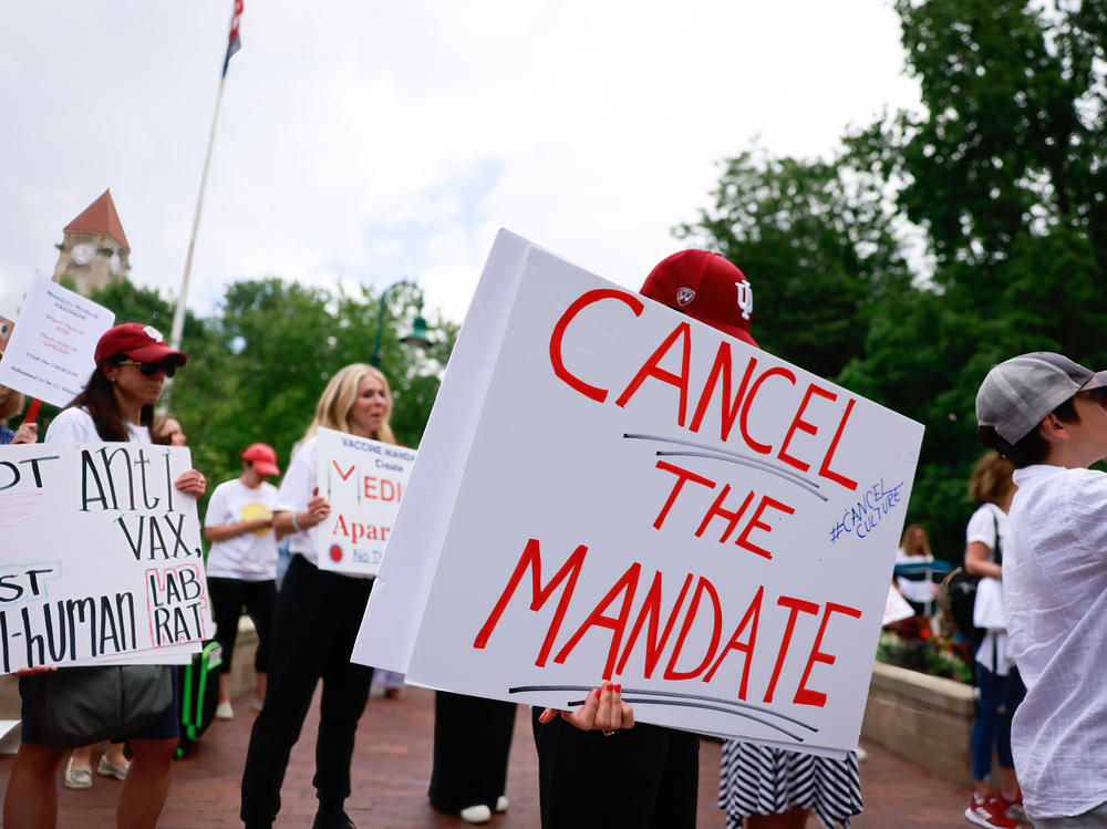People gather last month on Indiana University's Bloomington campus to protest the college's vaccine requirement. A group of students sued the school, claiming the policy violated their rights.