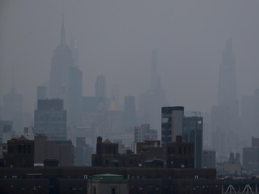 A thick haze hangs over Manhattan on Tuesday. Wildfires in the West, including the Bootleg Fire in Oregon, are creating hazy skies and poor air quality as far away as the East Coast.
