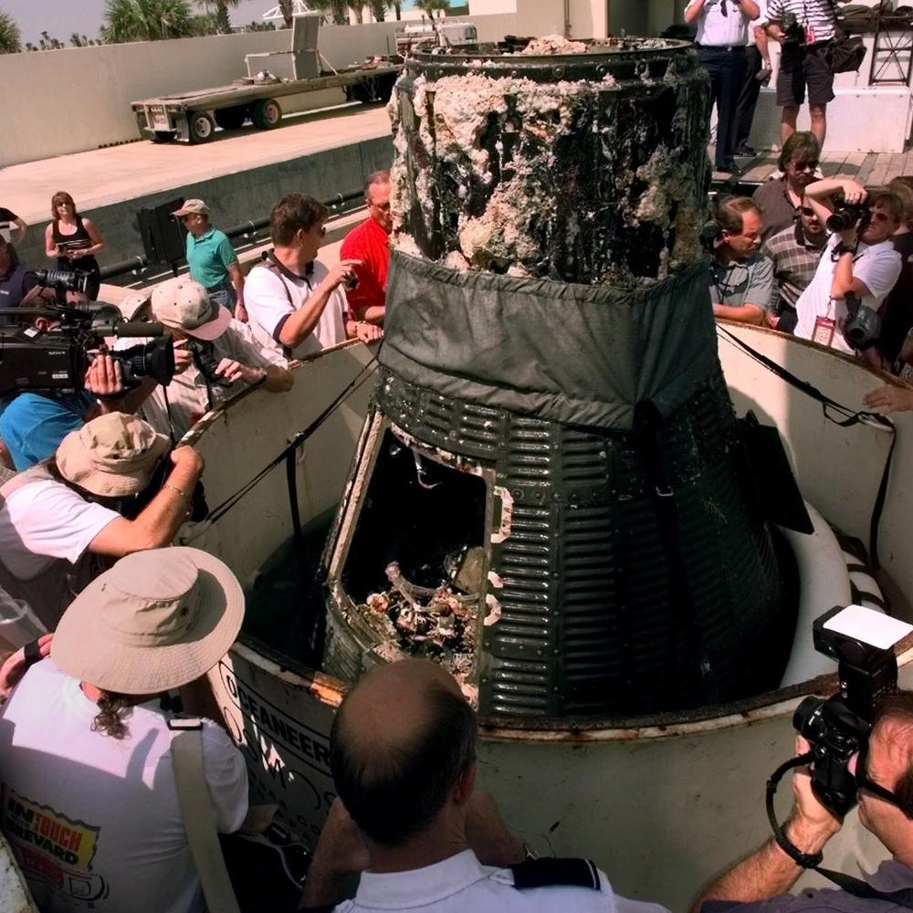 Members of the media surround the Mercury space capsule Liberty Bell 7 Wednesday, on July 21, 1999 at Port Canaveral, Fla., after the recovered craft was brought to shore by a salvage team financed by the Discovery Channel.