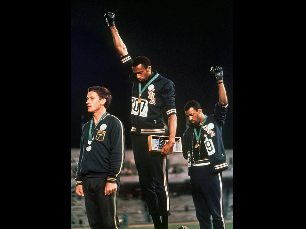 In a famous moment from the 1968 Summer Olympics in Mexico City, U.S. athletes Tommie Smith (center) and John Carlos raise their gloved fists after Smith received the gold medal and Carlos the bronze for the 200-meter run.