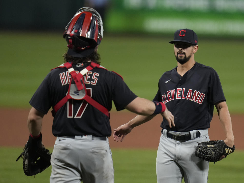 Cleveland relief pitcher Nick Sandlin (right) and catcher Austin Hedges celebrate a 10-1 victory over the St. Louis Cardinals on June 8. On Friday, the Cleveland team announced its new name, the Guardians.