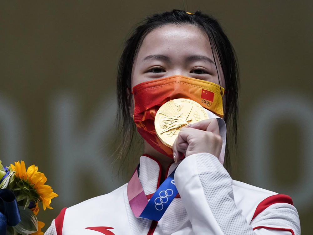 Qian Yang of China celebrates after winning the gold medal in the women's 10-meter air rifle at the Asaka Shooting Range in the Summer Olympics on Saturday.