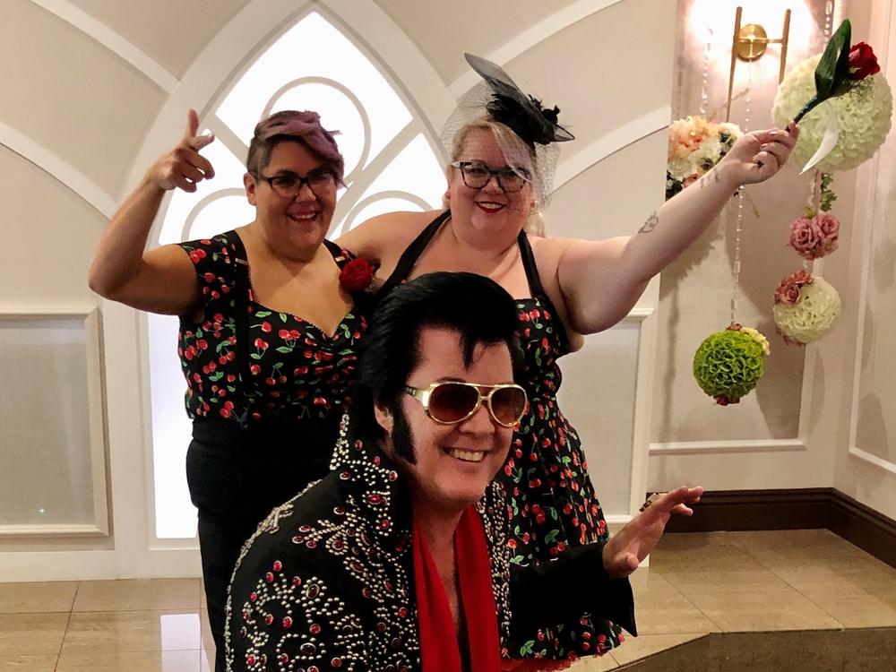 Brendan Paul (center) poses in front of newlyweds Jess Sandoval and Alana Stroebel at the Graceland wedding chapel in downtown Las Vegas.