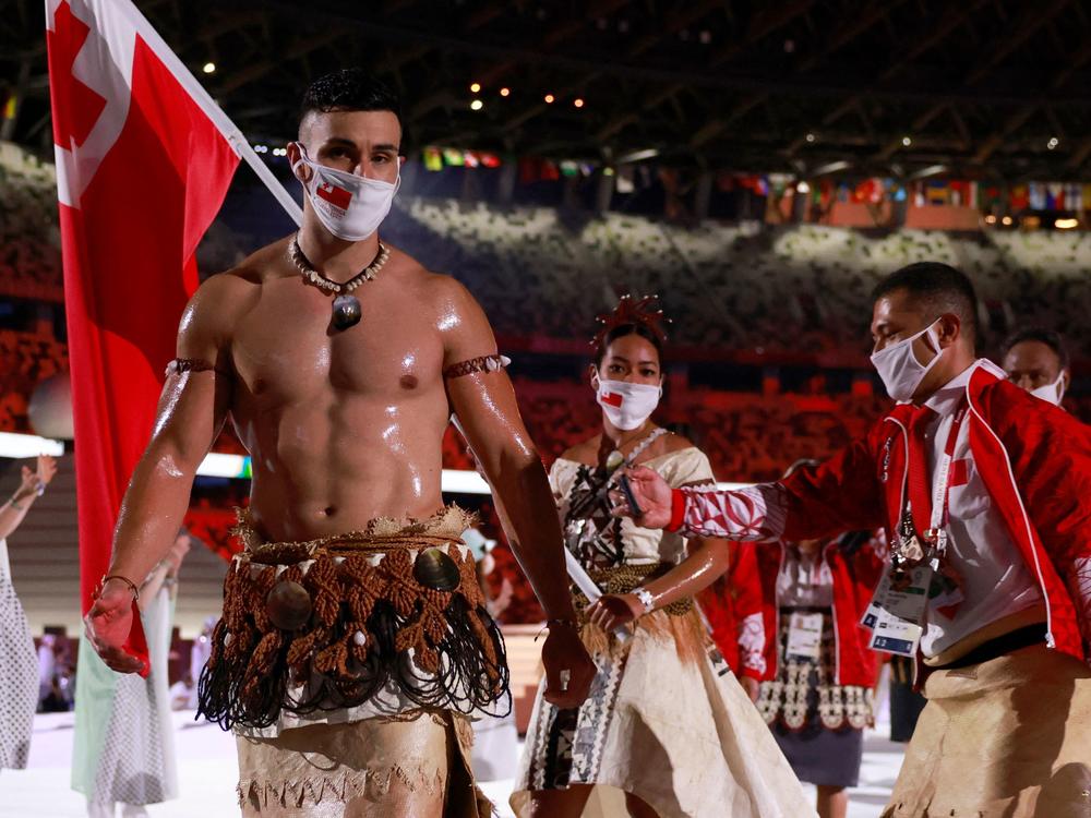Tonga's flag bearers Pita Taufatofua (left) and Malia Paseka lead their delegation into the opening ceremony of the Tokyo Olympic Games.