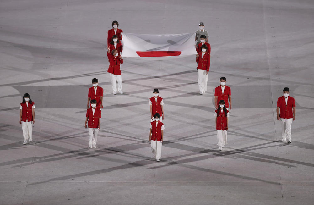 The Japanese national flag comes onto the stage during the opening ceremony.