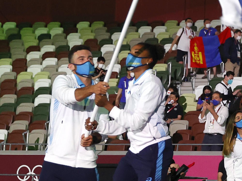 Uruguay flag bearers Deborah Rodriguez and Bruno Cetraro Berriolo lead their team out during the opening ceremony of the Tokyo 2020 Olympic Games at Olympic Stadium.