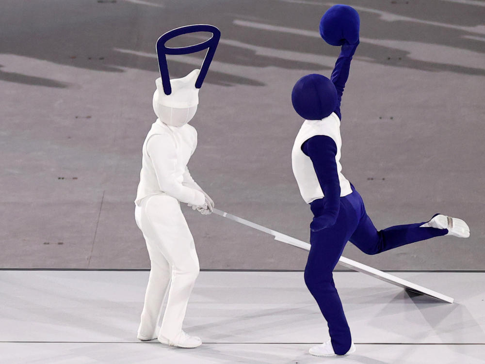 Performers acted out pictograms of basketball and other Olympic sports during the Tokyo Olympics' opening ceremony.