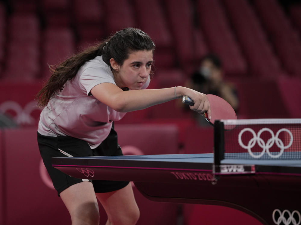 Syria's Hend Zaza competes during a women's table tennis singles preliminary round match against Austria's Liu Jia at the Summer Olympics in Tokyo.