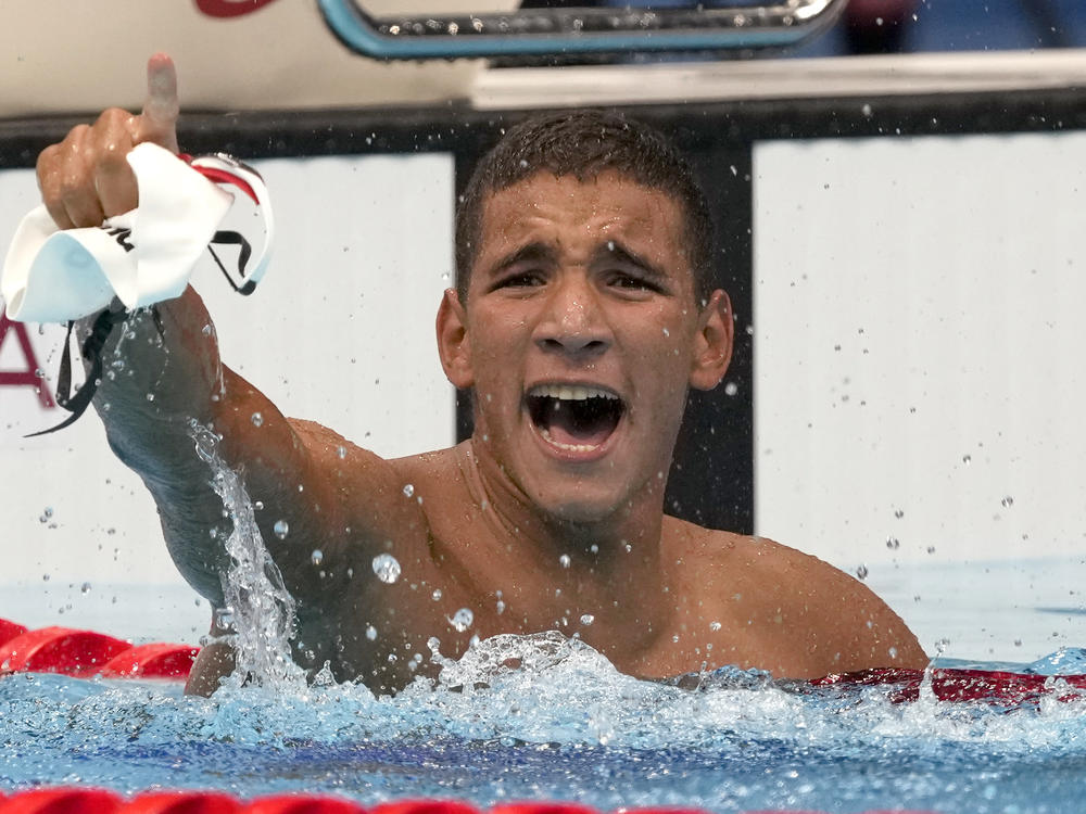 Tunisia's Ahmed Hafnaoui celebrates after his unexpected victory in the final of the men's 400-meter freestyle at the 2020 Summer Olympics in Tokyo.
