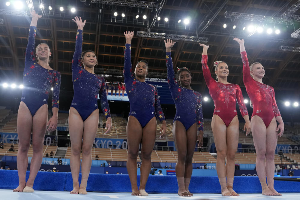 The United States' team wave prior to their women's artistic gymnastic qualifications performance at the 2020 Summer Olympics on Sunday in Tokyo.