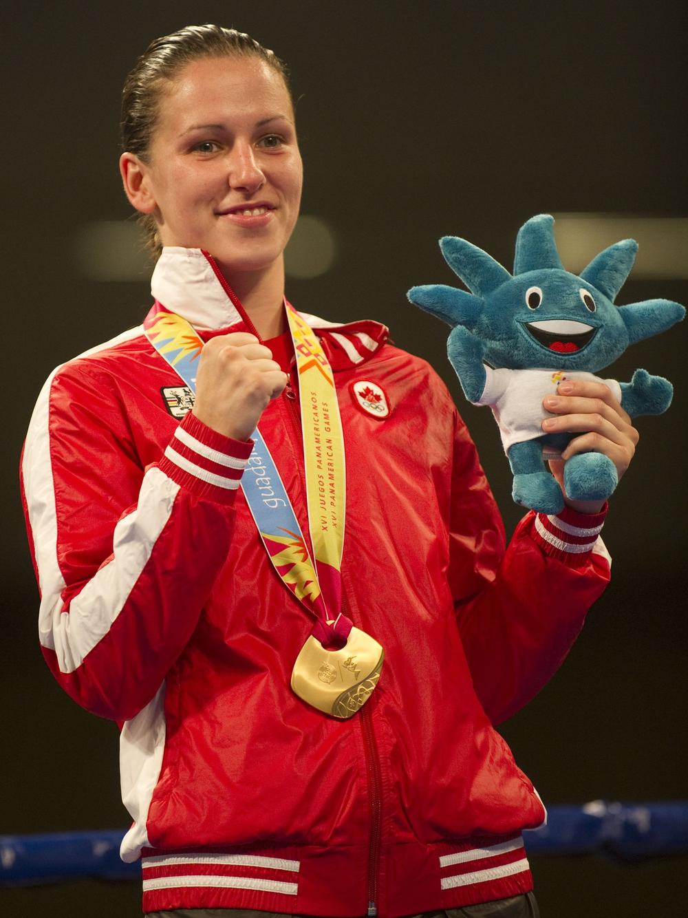 Canadian Mandy Bujold celebrates with her Gold medal after finish in the women's 51Kg weight final encounter during the 2011 Pan-American Games in Mexico.