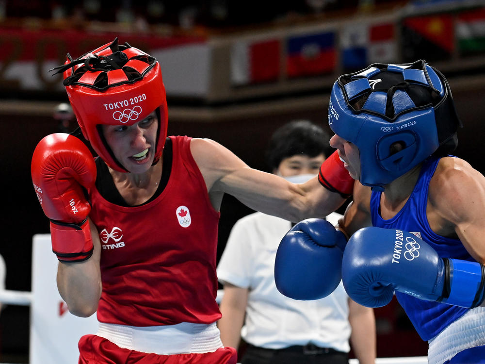 Mandy Bujold (L) of Canada exchanges punches with Nina Radovanovic of Serbia during the Women's Fly on Sunday at the Tokyo Olympics.