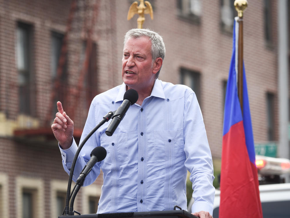 New York City Mayor Bill de Blasio said Monday that city workers will be required to be vaccinated or get tested weekly for COVID-19. De Blasio is seen here in Brooklyn on Sunday at a rally in support of Haiti.