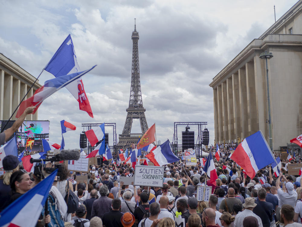 Thousands of protesters gather near the Eiffel Tower to protest the COVID-19 pass which grants vaccinated individuals greater ease of access to venues.