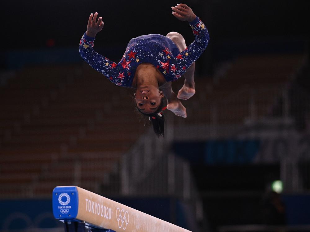 Simone Biles competes in the artistic gymnastics balance beam event of the women's qualification during the Tokyo 2020 Olympic Games at the Ariake Gymnastics Centre in Tokyo. The U.S. will face off with other top qualifiers early Tuesday.