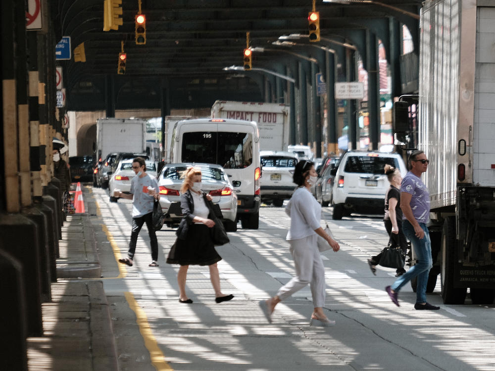 People walk along a main street in Brighton Beach, Brooklyn on Thursday in New York City.