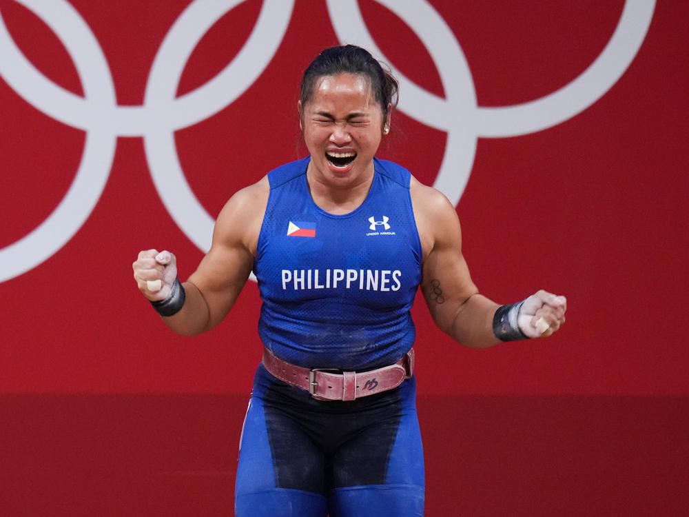 Hidilyn Diaz of the Philippines celebrates winning the women's 55-kilogram weightlifting match at the Tokyo 2020 Games — her country's first Olympic gold medal.