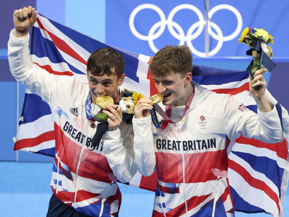Tom Daley, left, and Matty Lee celebrate their win in the men's synchronized 10m platform final on day three of the Tokyo 2020 Olympic Games.