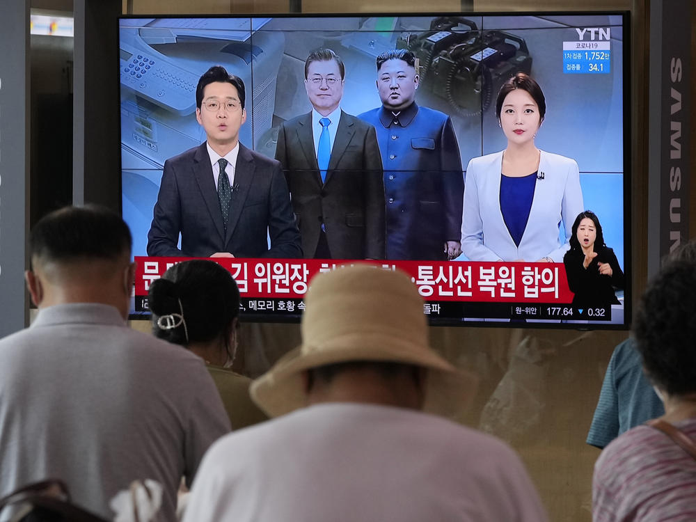 A news program at the Seoul Railway Station broadcasts a report on the resumption of communication between North and South Korea on Tuesday.